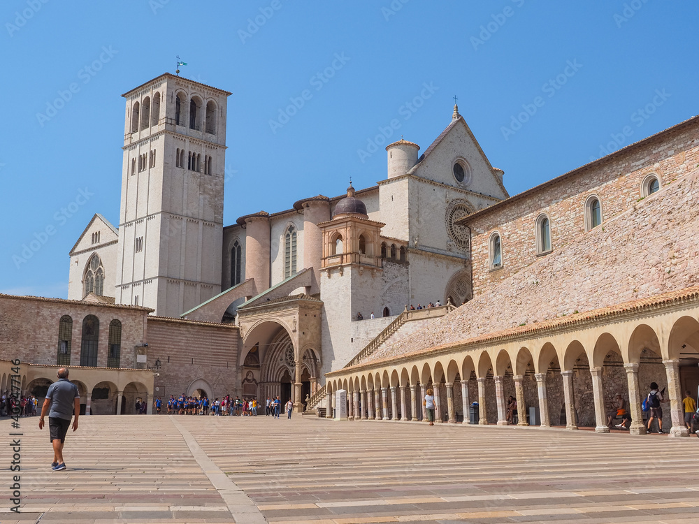 Papal Basilica of Saint Francis of Assisi or Basilica di San Francesco d'Assisi. Lower and Upper Churches, seen from the arched square Lower Plaza or Piazza Inferiore. Place of Christian pilgrimage.