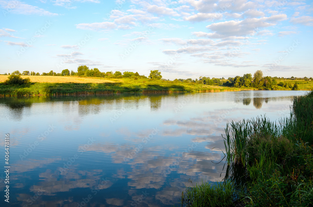 Summer tranquil landscape with river and beautiful reflection of sky clouds on water surface. Summer tranquil landscape with river and beautiful reflection of sky clouds on water surface.