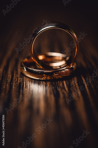 Gold wedding rings on brown wood