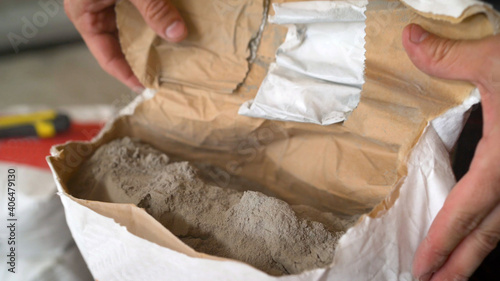 Cement or grout in a construction bag. Cement powder in bag package. Dry mortar for laying the floor in a bag.