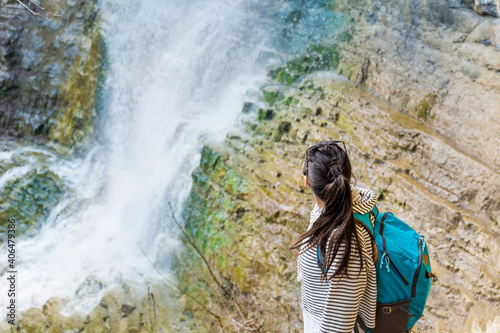 Young Tourist Woman in the Mountain Looking a Spring Waterfall