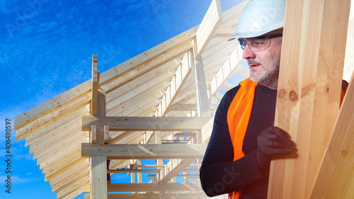 Builder with boards in his ...