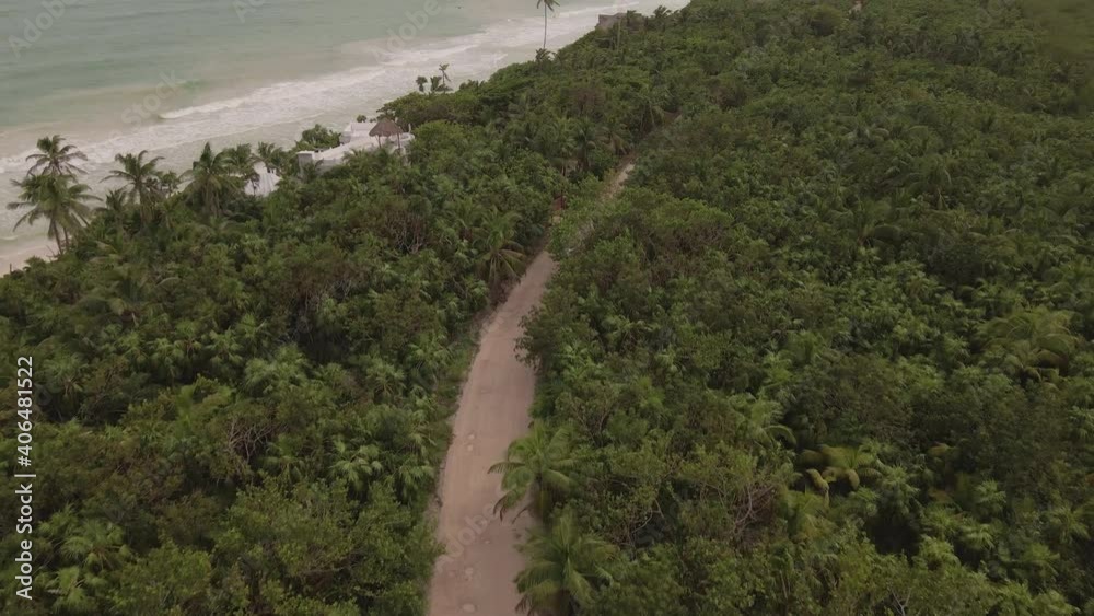 Aerial View, White Car Moving on Dirty Road in Rainforest by Caribbean Sea Coast of Mexico Aerial View, White Car Moving on Dirty Road in Rainforest by Caribbean Sea Coast of Mexico
