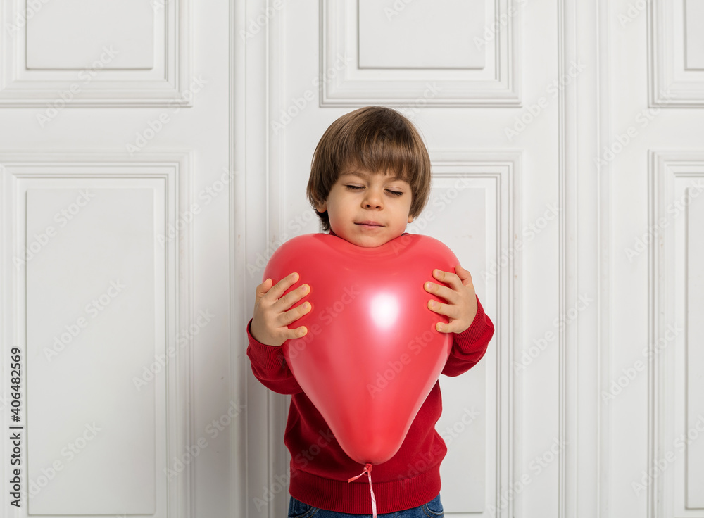 dreamy boy holding red balloon heart on white background dreamy boy holding red balloon heart on white background