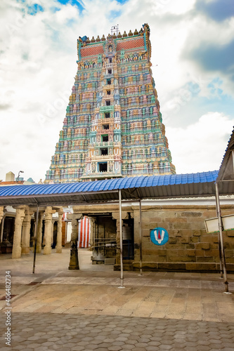 Entrance Tower, or Rajagopuram, to Temple dedicated to Hindu Deities, Lord Vishnu and Goddess Andal, at Srivilliputhur, Tamilnadu, India. Built in the 10th century CE, tower has exquisite carvings.   photo