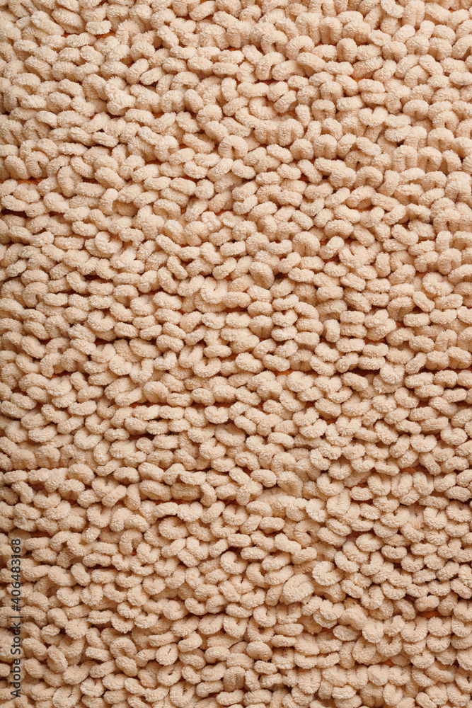 The structure of beige wool fibers in full screen as a background. The structure of beige wool fibers in full screen as a background.