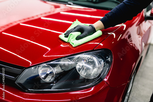 A man cleaning car with cloth  car detailing  or valeting  concept. Selective focus.