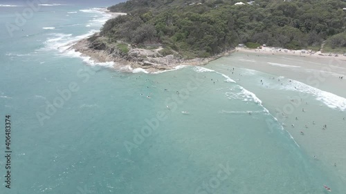 Tourists Swim And Surf At Crystal Clear Water Of Cylinder Beach In Summer - North Stradbroke Island, QLD, Australia. - aerial photo