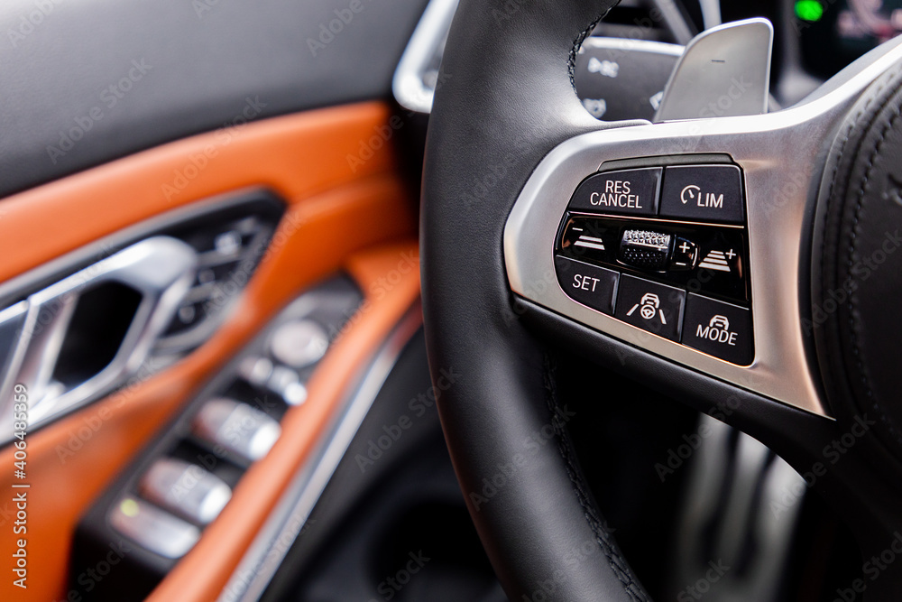 Buttons on steering wheel in interior of a car
