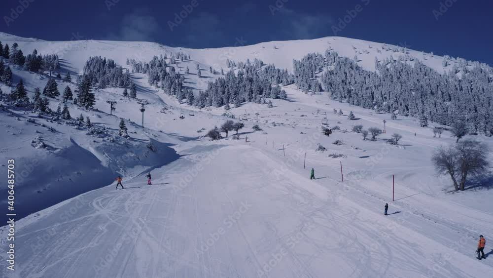 People enjoying the pure white snow of Kalavryta, Greece in winter - aerial People enjoying the pure white snow of Kalavryta, Greece in winter - aerial