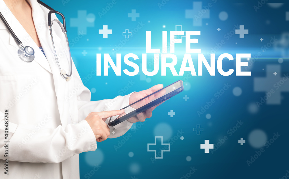 doctor writes notes on the clipboard with LIFE INSURANCE inscription, first aid concept doctor writes notes on the clipboard with LIFE INSURANCE inscription, first aid concept