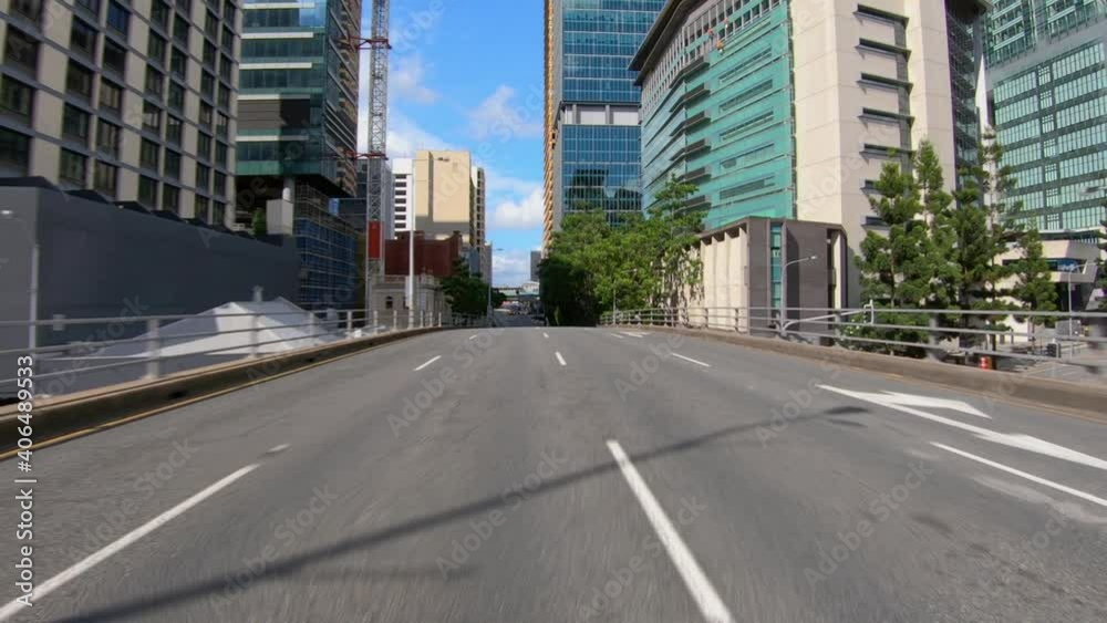 Rear facing driving point of view POV of city central business district CBD, on elevated section of road, with modern tower blocks - ideal for interior car scene green screen replacement