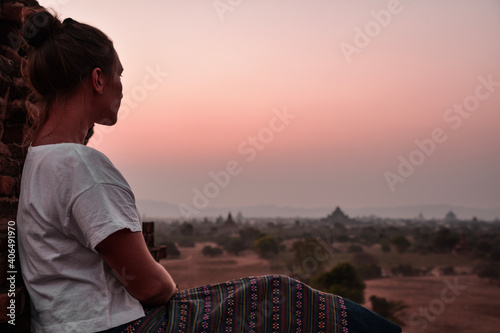 Fototapeta Naklejka Na Ścianę i Meble -  young woman looking at sunset in Bagan, Myanmar