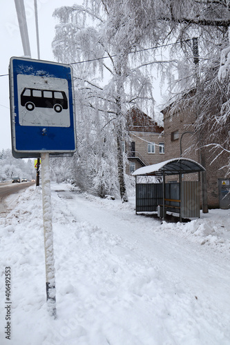 bus stop sign on winter road in the city