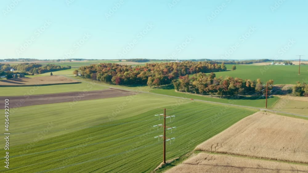 Drone shot of power lines and field with autumn leaves Drone shot of power lines and field with autumn leaves
