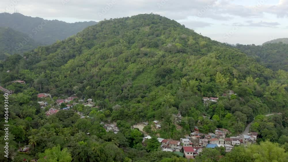 Drone video from above with houses built in green jungle in a Philippines. Drone video from above with houses built in green jungle in a Philippines.