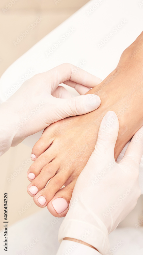 Pedicure nail spa procedure. Foot manicure. Salon master. Polish woman leg. Hands in gloves. Light background. Massage service. Healthy toe cleaning. Pink pastel color. Dermatology cream Pedicure nail spa procedure. Foot manicure. Salon master. Polish woman leg. Hands in gloves. Light background. Massage service. Healthy toe cleaning. Pink pastel color. Dermatology cream