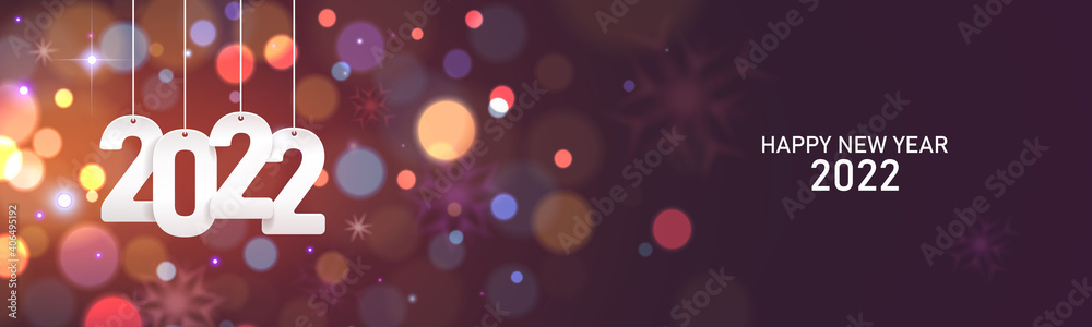 Happy new year 2022. Hanging white paper number on a horizontal defocused colorful blurry background. Happy new year 2022. Hanging white paper number on a horizontal defocused colorful blurry background.