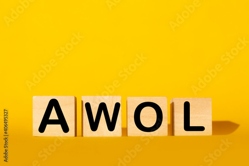 wooden cubes and AWOL on a yellow background.the concept of taxation, increase taxes