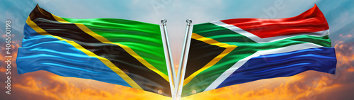 Double Flag South Africa and Tanzania flag waving flag with texture sky Cloud and sunset background