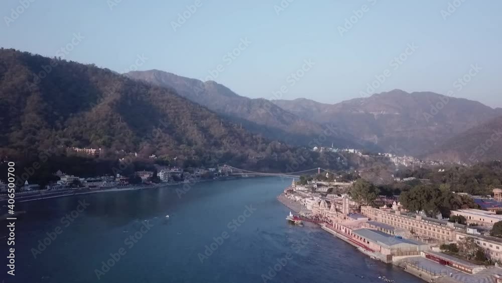 Scenic View Of The Sacred Ganges River Flowing Through The Green Mountains Of Rishikesh, Uttarakhand, India - aerial drone shot Scenic View Of The Sacred Ganges River Flowing Through The Green Mountains Of Rishikesh, Uttarakhand, India - aerial drone shot