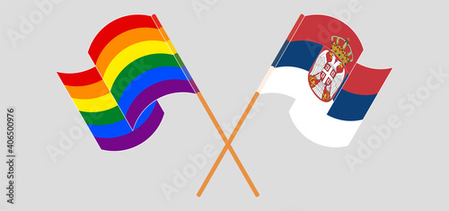 Crossed and waving flags of LGBTQ and Serbia