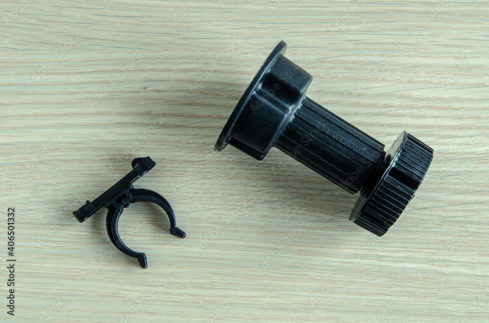furniture black plastic support for kitchen set, on wooden background. furniture black plastic support for kitchen set, on wooden background.