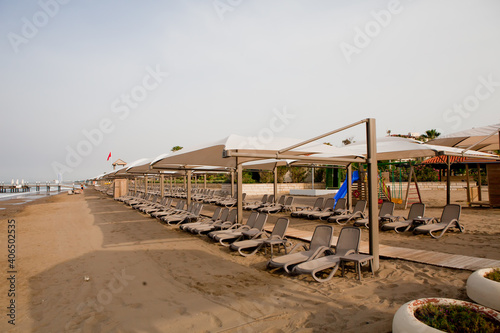 Beach near the sea with sun loungers and parasols