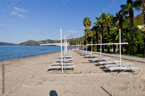 Beach near the sea with sun loungers and parasols