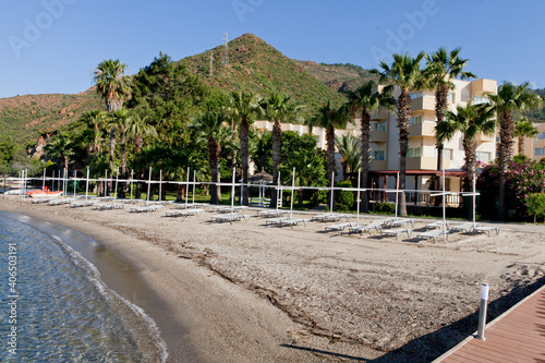 Beach near the sea with sun loungers and parasols