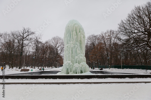 Frozen fountain in winter. The fountain was frozen all over in ice.