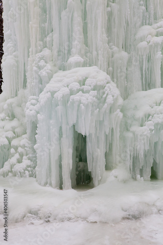 Frozen fountain in winter. The fountain was frozen all over in ice.