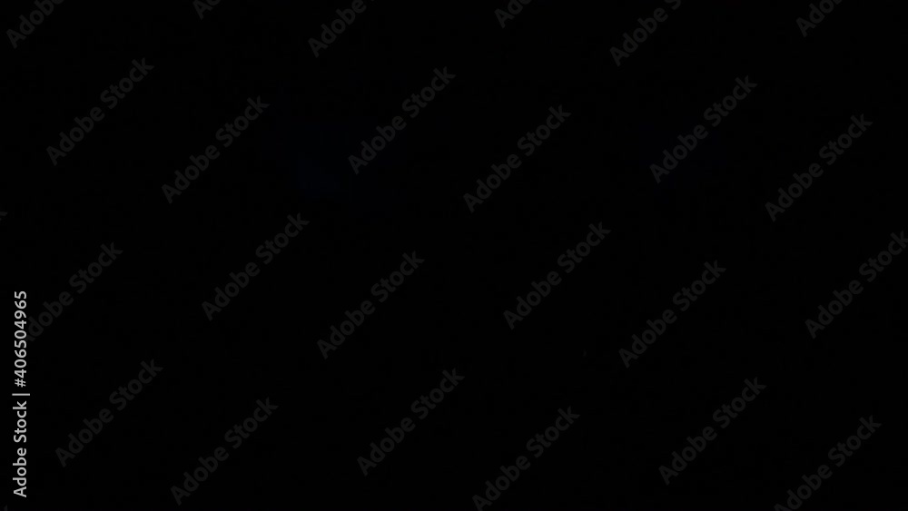 Camera follows young brunette woman in red jacket walks quickly along long corridor with flashes in the dark. Camera follows young brunette woman in red jacket walks quickly along long corridor with flashes in the dark.