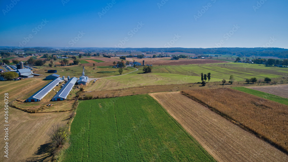 Aerial View of Multiple Farms and Pastures with Field of Corn and other Vegetables Growing on Them on a Beautiful Summer Day