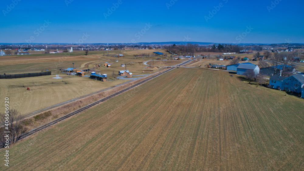 Aerial View of Farmlands a Rail Road Track and a Play Area in Winter