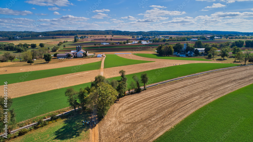 Aerial View of Multiple Farms and Train Tracks going Thru Them on a Beautiful Summer Day