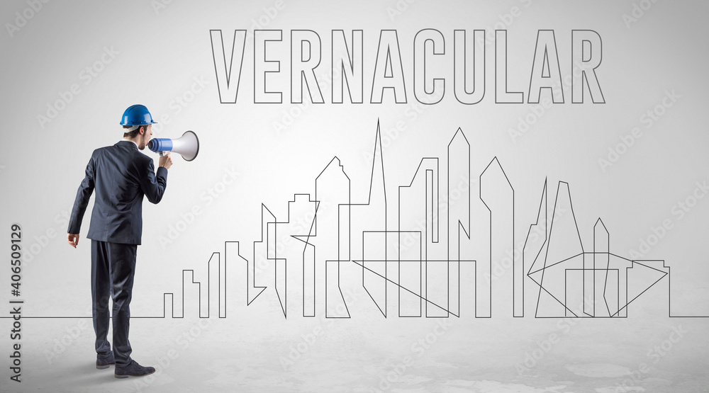 Businessman in hard hat holding blueprint with VERNACULAR inscription, engineering and architecture concept Businessman in hard hat holding blueprint with VERNACULAR inscription, engineering and architecture concept