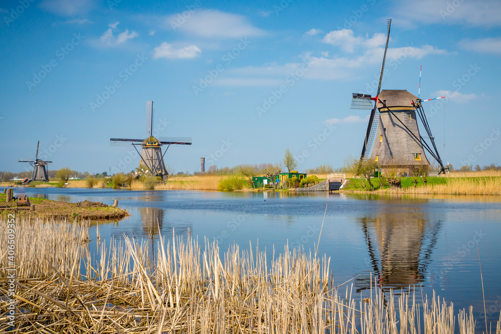 Bright sunny landscape of old fashioned windmills that still work today