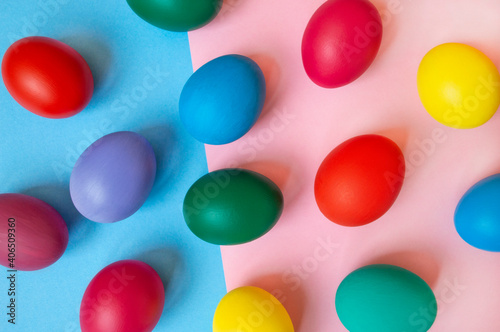 colorful easter eggs on pink background with copy space. Easter background