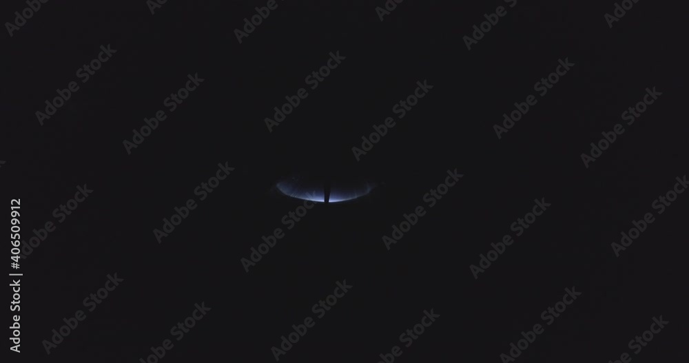 A girl walks alone in the winter through the forest at night, with a flashlight in her hands. Aerial footage. A girl walks alone in the winter through the forest at night, with a flashlight in her hands. Aerial footage.