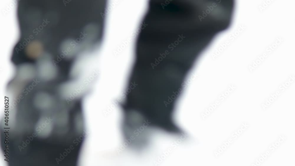 Cinematic rough jerky camera action of a man walking in and out of focus in snow shoes in the Canadian arctic. Wearing classic Inuit snow shows. Cinematic rough jerky camera action of a man walking in and out of focus in snow shoes in the Canadian arctic. Wearing classic Inuit snow shows.