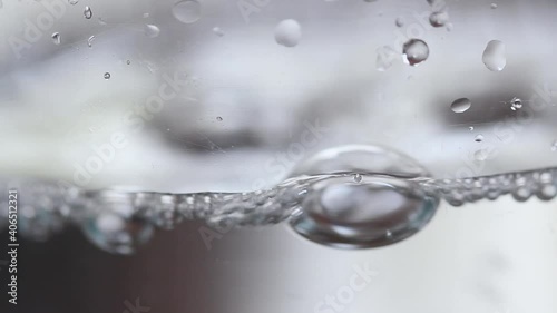 Water Poring Into Glass. water bubbles closeup.
water drops photo