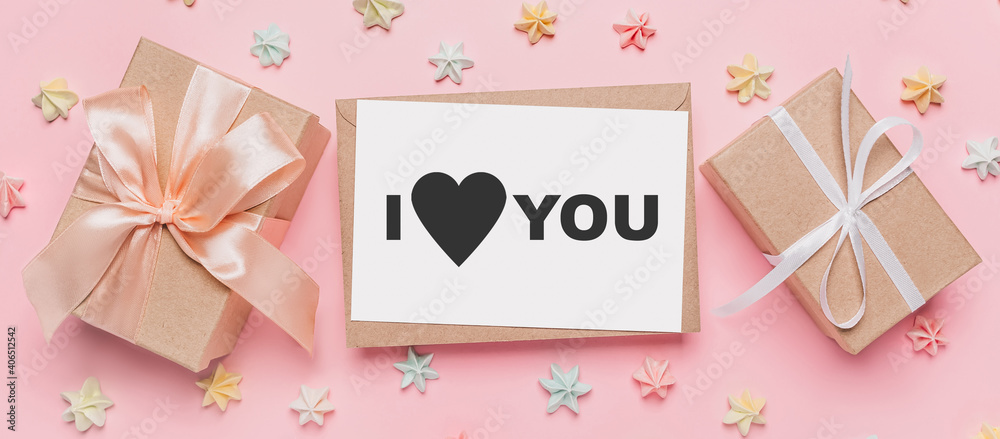 Gifts with note letter on isolated pink background with sweets, love and valentine concept with text I love you
