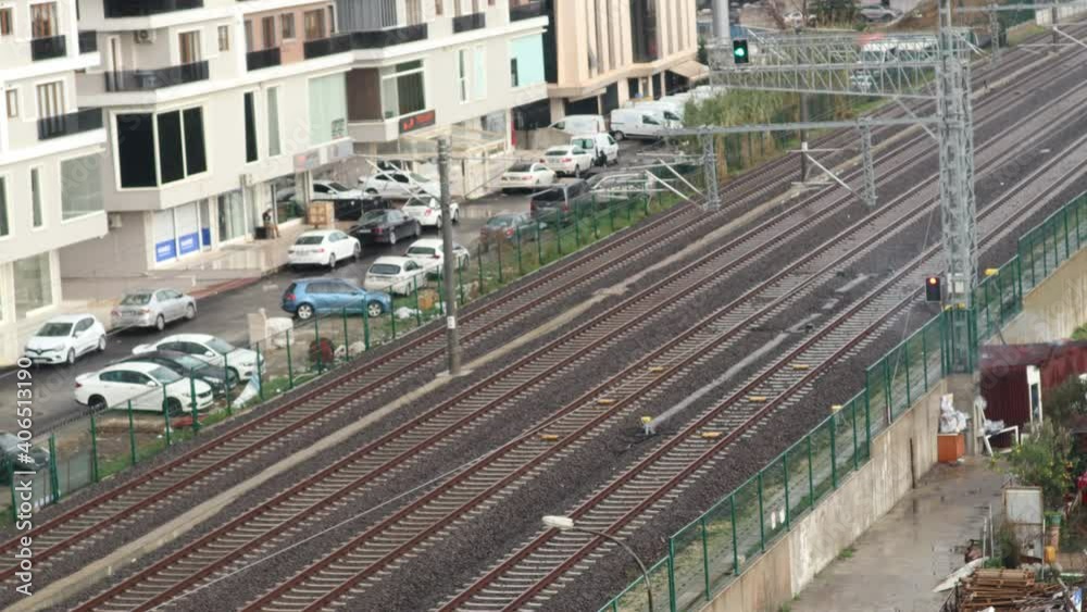 Train view in a station with time-lapse buildings. View of the rails inside the station. cars and the flow of life. Close-up. Train view in a station with time-lapse buildings. View of the rails inside the station. cars and the flow of life. Close-up.
