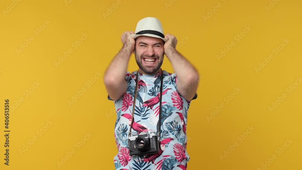 Surprised overjoyed traveler tourist man in summer clothes hat isolated on yellow background. Passenger traveling on weekend. Air flight journey concept. Doing winner gesture screaming clenching fists Surprised overjoyed traveler tourist man in summer clothes hat isolated on yellow background. Passenger traveling on weekend. Air flight journey concept. Doing winner gesture screaming clenching fists