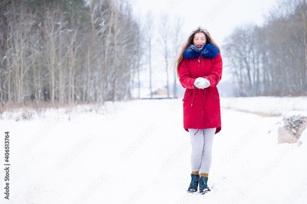 Young woman in red coat walk on winter road Young woman in red coat walk on winter road