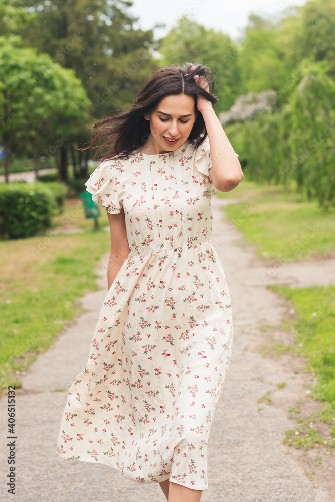 Young elegant girl posing at city street. Pretty beautiful business woman in elegant dress against city background. Young elegant girl posing at city street. Pretty beautiful business woman in elegant dress against city background.