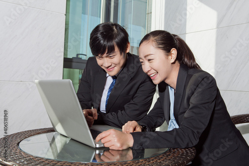 Business man and business woman using laptop © eastfenceimage