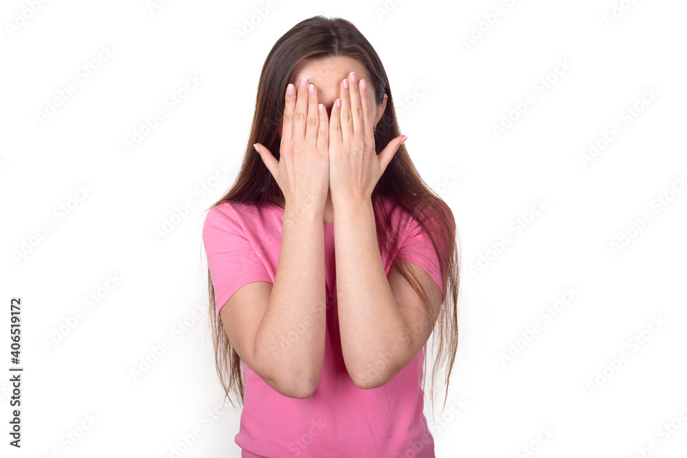 Shock. Brunette woman in pink sweater covering her face with her hands, isolated on white background. Place for text. Shock. Brunette woman in pink sweater covering her face with her hands, isolated on white background. Place for text.
