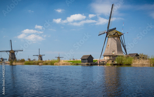 Nine windmills in Holland Holland field by water © Jo